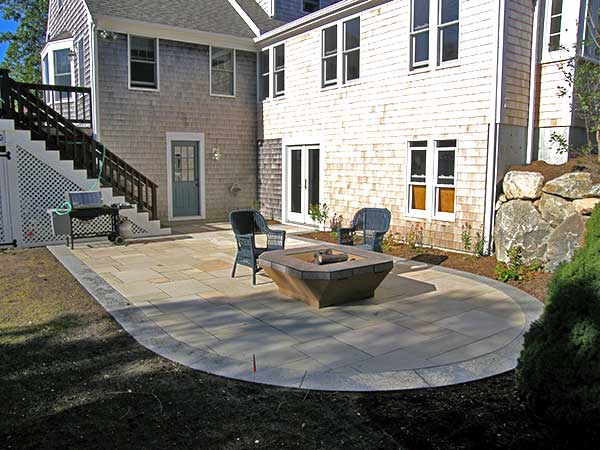 Landscaping and yard maintenance services. Chatham stone fire pit.